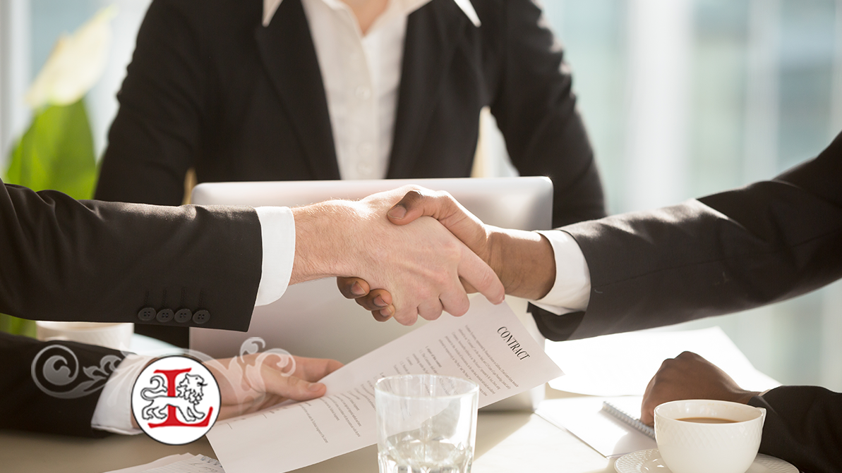 Multi ethnic businesspeople shaking hands at negotiation table after singing contract in presence of female secretary