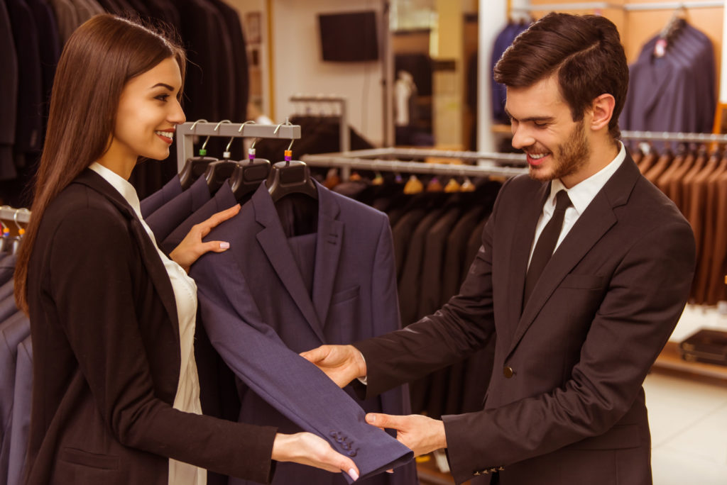 image consultant looking over suit with male client 