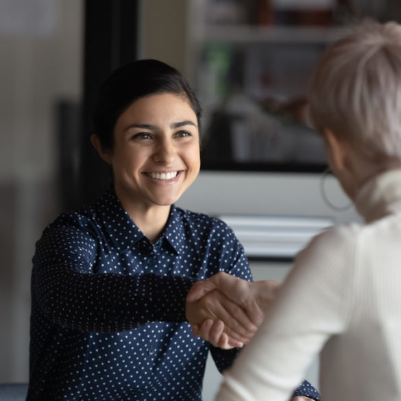 Happy employer shaking hands making a good first impression